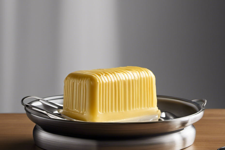 An image showing a butter dish placed on a kitchen countertop with a stick of butter, partially melted, next to it
