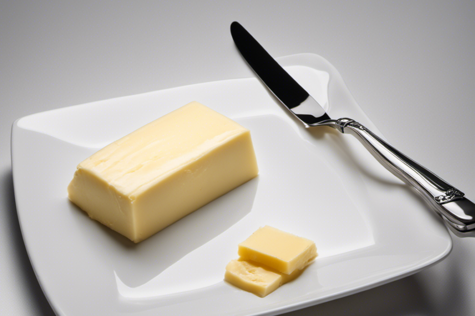 An image showcasing a 125g slab of butter on a clean white plate, with a silver knife beside it