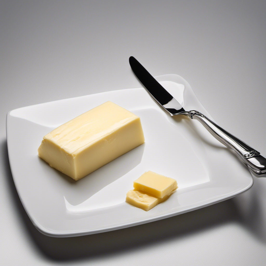 An image showcasing a 125g slab of butter on a clean white plate, with a silver knife beside it