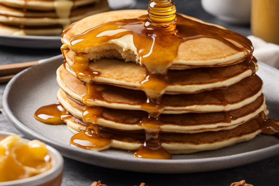 An image showcasing a warm, golden-hued honey butter glaze being gently drizzled over a stack of fluffy pancakes