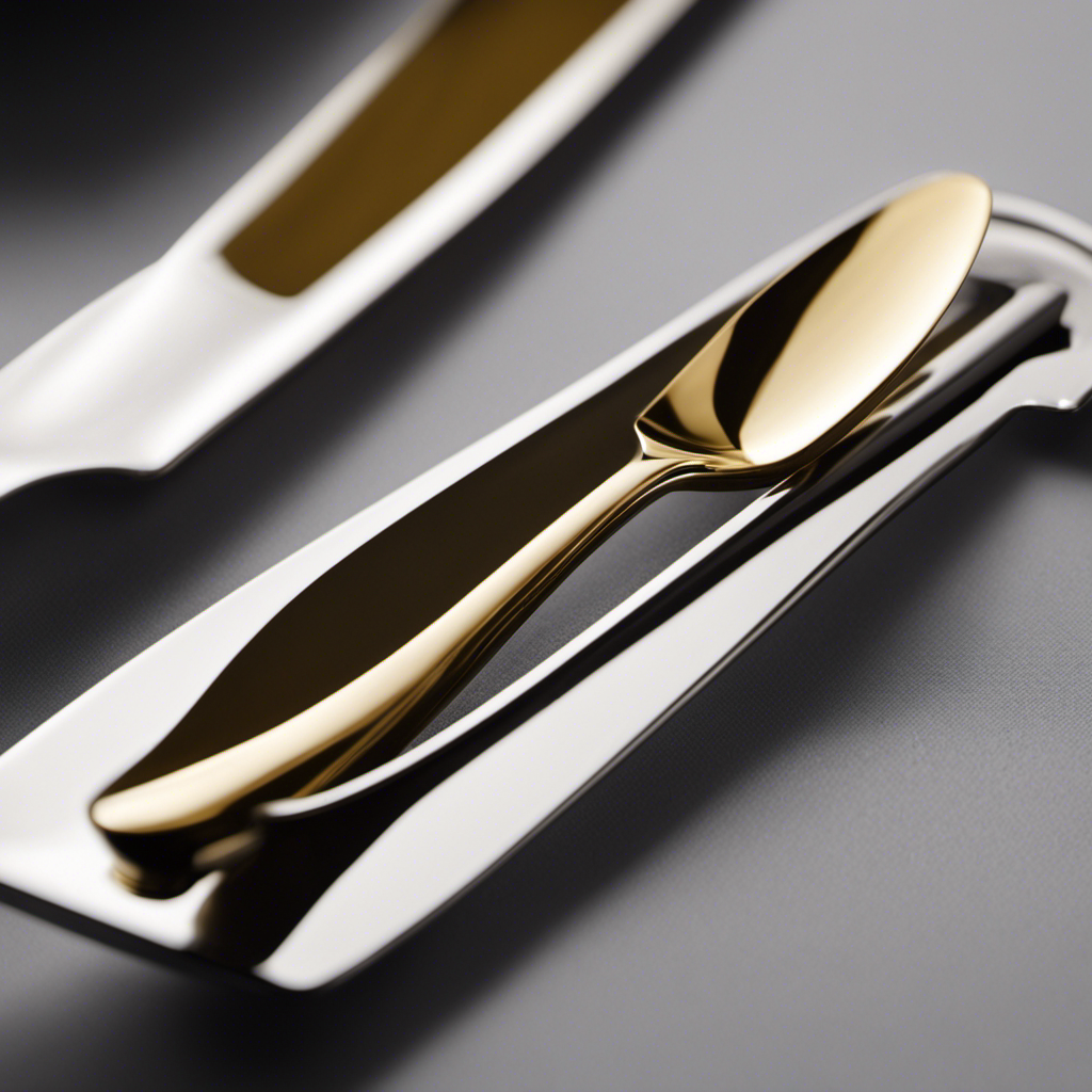 An image that showcases the elegant simplicity of a butter knife, capturing its slender, rounded handle and smooth, flat blade gliding effortlessly through a golden pat of butter, ready to enhance a warm slice of bread