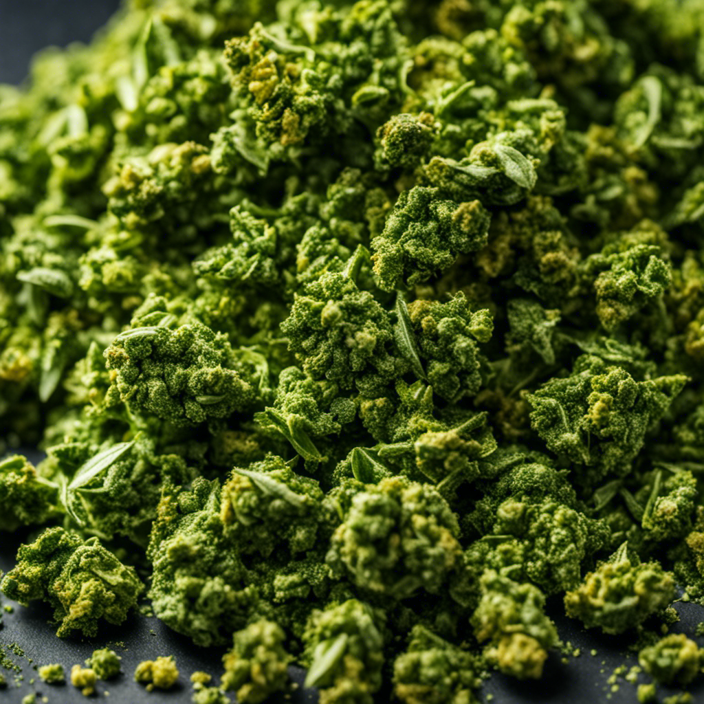 An image showcasing a close-up of a small amount of marijuana buds being delicately crumbled into a vibrant green powder, ready to be used in a cannabutter maker