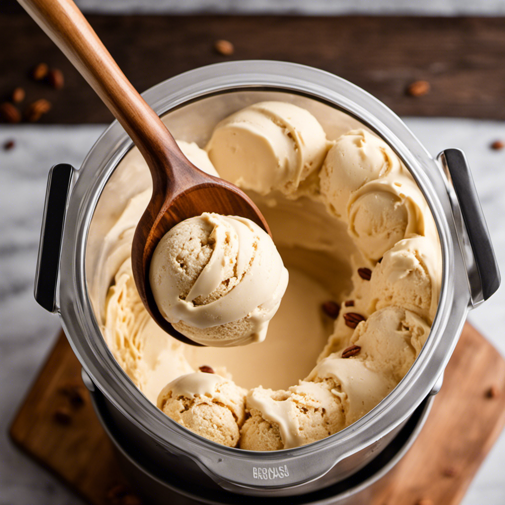 An image showcasing a close-up shot of a hand churning golden-brown butter pecan ice cream batter in an ice cream maker