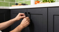 Black, Bold Cabinets and Dramatic Green Tiles Refresh This 2000s Kitchen