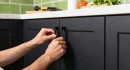 Black, Bold Cabinets and Dramatic Green Tiles Refresh This 2000s Kitchen